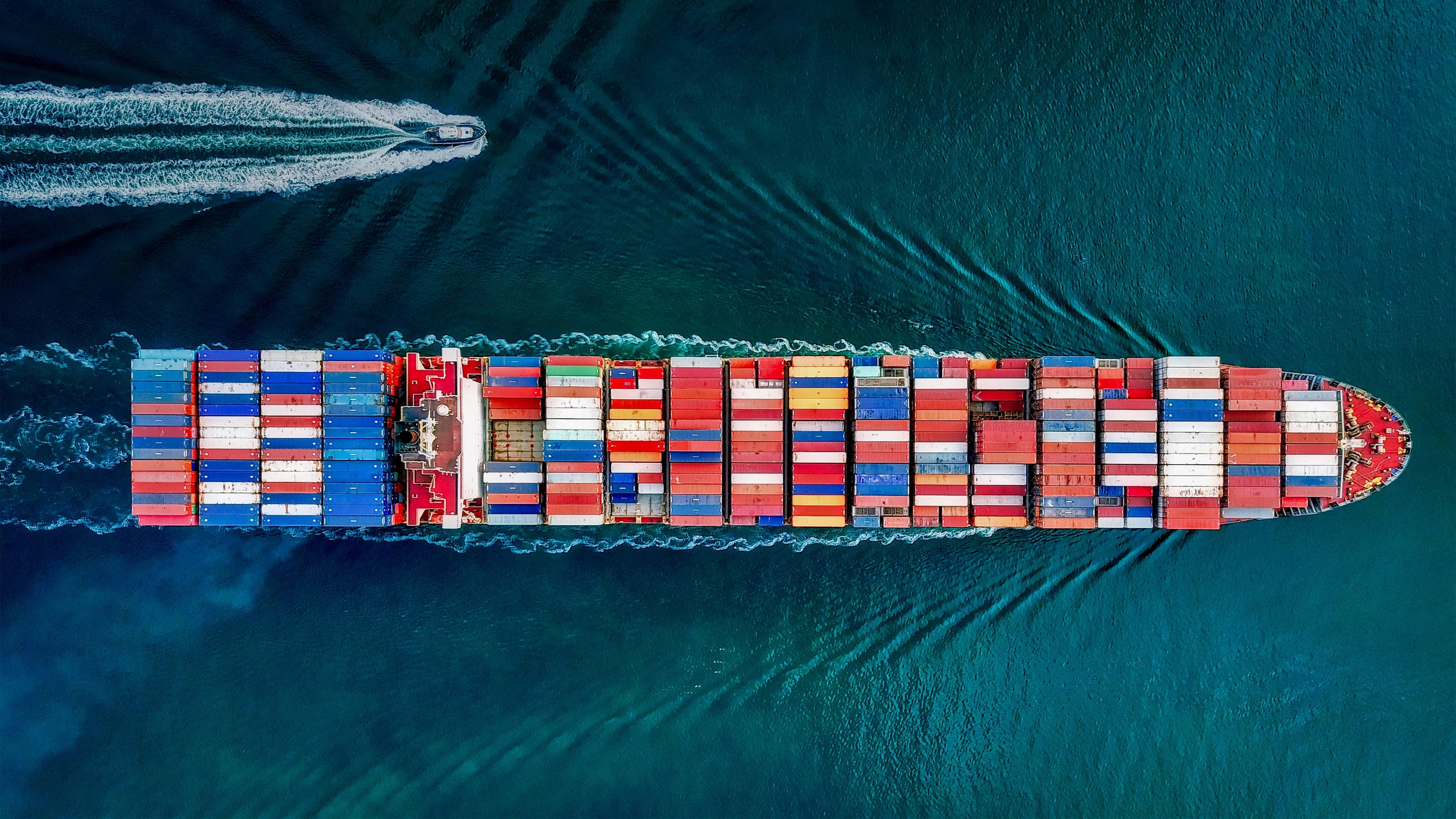 Commercial maritime cargo vessel sailing across the ocean - Taneet Maritime Fleet Management Platform